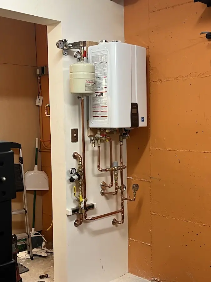 Plumbing technician inspecting water heater connections in Palm Coast